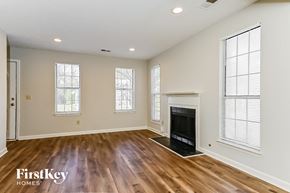 Rex house for rent - a living room with a fireplace and wooden floors