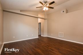 Orlando house for rent - A spacious room with a ceiling fan and wooden flooring.