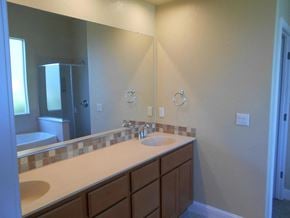 Manteca house for rent - a bathroom with two sinks and a large mirror