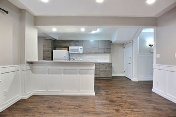 Regina apartment for rent - A kitchen with white cabinets and a white fridge.
