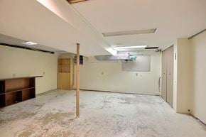 Regina apartment for rent - A room with a concrete floor and a wooden support beam.