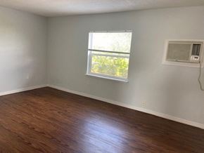 Orlando apartment for rent - an empty room with a window and wooden floors