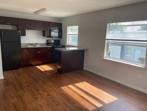 Orlando apartment for rent - an empty kitchen with wooden floors and a window