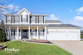 O'fallon house for rent - a white house with white garage doors and a lawn