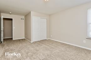 O'fallon house for rent - a bedroom with a white door and a carpeted floor