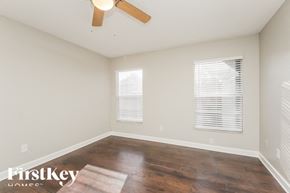 Saint Cloud house for rent - a living room with wood floors and a ceiling fan