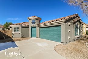 Surprise house for rent - a single story home with a green garage door