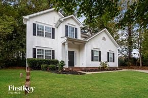 Huntersville house for rent - a white house with black shutters and a lawn
