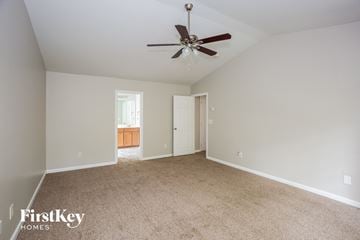 Huntersville house for rent - a spacious living room with carpet and a ceiling fan