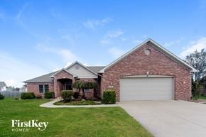 Camby house for rent - a brick house with a white garage door
