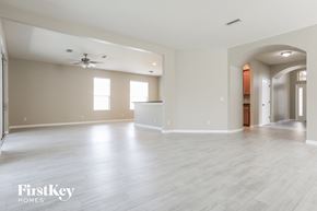 North Port house for rent - the living room and dining room with the kitchen in the background