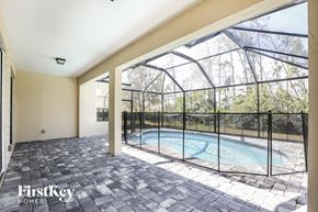 North Port house for rent - the pool is in the back of the house with a large window and a fence