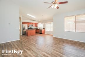 San Tan Valley house for rent - A spacious living room with wooden floors and a ceiling fan.