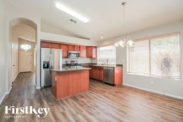 San Tan Valley house for rent - A kitchen with wooden floors and a refrigerator.