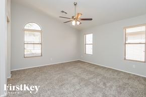 San Tan Valley house for rent - A spacious room with a ceiling fan and two windows.