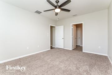 Wesley Chapel house for rent - a spacious living room with carpet and a ceiling fan