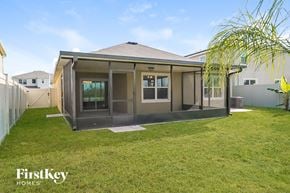 Wesley Chapel house for rent - a home with a patio and a grass yard