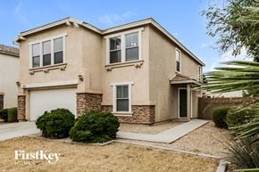 Glendale house for rent - a beige house with a garage and a sidewalk in front