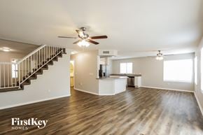 Glendale house for rent - a living room with a staircase and a ceiling fan
