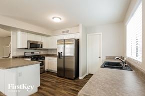 Glendale house for rent - a kitchen with white cabinets and stainless steel appliances
