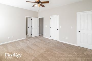 Summerville house for rent - a living room with carpet and a ceiling fan