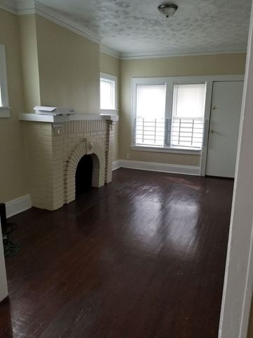Cleveland apartment for rent - a living room with a fireplace and a wooden floor