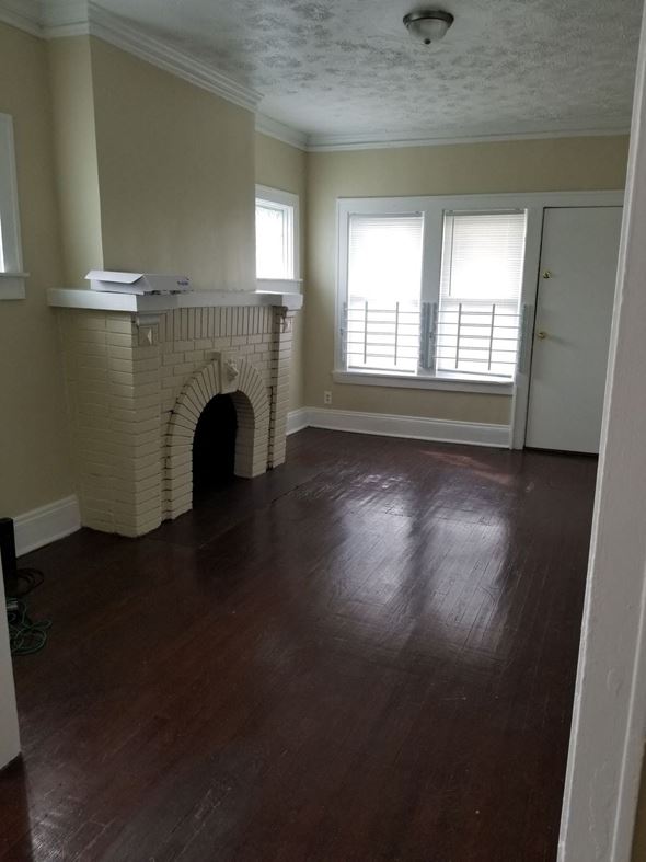 Cleveland apartment for rent - a living room with a fireplace and a wooden floor