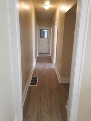 Cleveland apartment for rent - a hallway with wooden floors and a white door