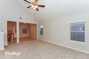Cypress house for rent - A spacious room with a ceiling fan and a window with blinds.