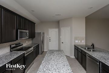 Glenn Heights house for rent - a kitchen with granite counter tops and stainless steel appliances