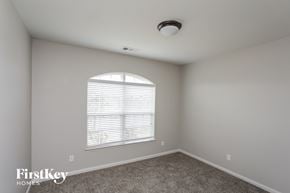 Glenn Heights house for rent - a bedroom with a large window and a carpet