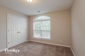 Monroe house for rent - a bedroom with a large window and a white door