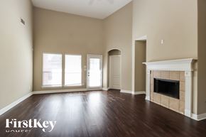 Porter house for rent - A spacious room with a fireplace and wooden floors.