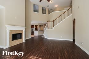 Porter house for rent - A spacious living room with wood flooring and a staircase leading to the upper level.
