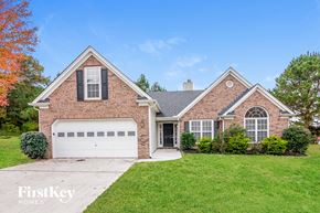 Union City house for rent - a brick house with a lawn and a white garage door