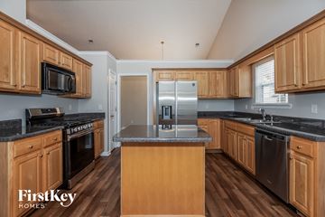 Union City house for rent - a kitchen with wooden cabinets and stainless steel appliances