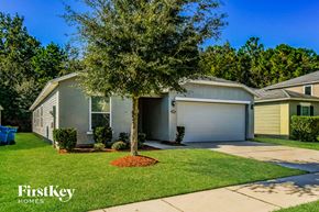 Jacksonville house for rent - A house with a tree in front of it and the words "FirstKey Homes" on the bottom left.