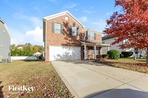 Monroe house for rent - a large brick house with a white garage door in front of it
