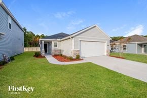 Jacksonville house for rent - a white house with a yard and a driveway