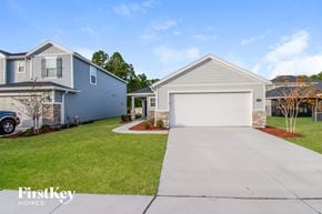 Jacksonville house for rent - a blue house with a white garage door and a driveway