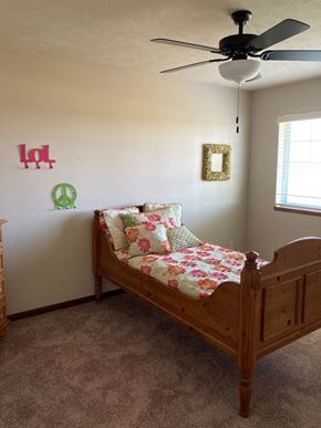 Lincoln house for rent - a bedroom with a bed and a ceiling fan