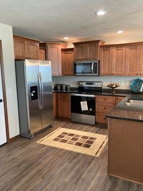 Lincoln house for rent - a kitchen with wooden cabinets and stainless steel appliances