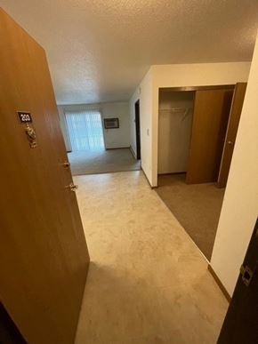 Fargo apartment for rent - A hallway with a door on the left and another door on the right.