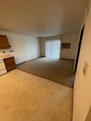 Fargo apartment for rent - A room with a brown carpet and a white wall.
