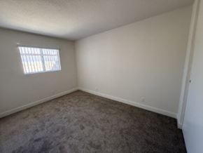 Anaheim apartment for rent - A room with a carpeted floor and a window.