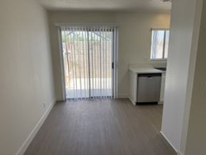 Anaheim apartment for rent - A room with a sliding glass door leading to a backyard.
