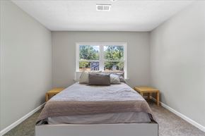 College Park apartment for rent - A bedroom with a large bed and a window overlooking a street.