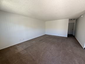 Garden Grove apartment for rent - A room with brown carpet and white walls.