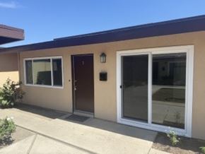 Garden Grove apartment for rent - A tan house with a brown door and a glass window.