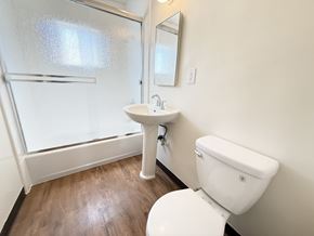 Anaheim apartment for rent - A white toilet sits next to a sink in a bathroom.